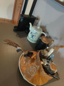 a plate with glasses and a teapot on a table at Casa Jolanda in Iolanda di Savoia
