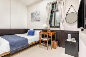 Ένα ή περισσότερα κρεβάτια σε δωμάτιο στο Jiufen Harmony Inn