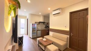a living room with a couch and a kitchen at Chilala Boutique & Apartment in Da Nang