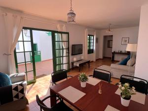 a living room with a table and a couch at Apartment Sonrisa - spacious two bedroom apartment in Costa Teguise