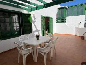 a white table and chairs on a patio at Apartment Sonrisa - spacious two bedroom apartment in Costa Teguise