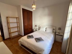 a bedroom with a bed with two towels on it at Apartment Sonrisa - spacious two bedroom apartment in Costa Teguise +8 photos