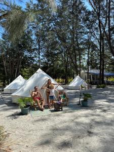 a group of people sitting in front of tents at Puerto Silanguin Beach Resort in Subic