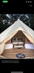a tent with a bunch of beds in it at Puerto Silanguin Beach Resort in Subic