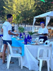 a man standing in front of a table with food at Puerto Silanguin Beach Resort in Subic