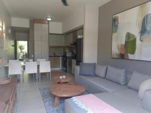 a living room with a couch and a table at Harolds Haven at The Bay in Herolds Bay