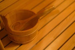 a wooden basket sitting on top of a wooden table at MIRATIO Sauna Onna in Onna