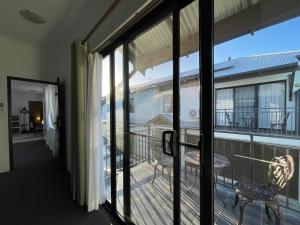 a room with a balcony with a view of the ocean at Equitice Spring Moonlight Villa - Shared Property in Perth