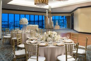 a table set up for a wedding in a room with windows at Miami Marriott Biscayne Bay in Miami +106 photos