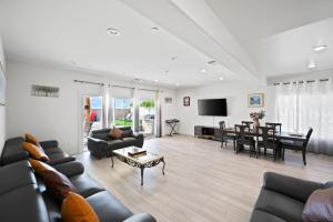 a living room with a couch and a table at Views, Gameroom, Saltwater Pool & Hot tub, Firepit by MariamsBnb in Desert Hot Springs