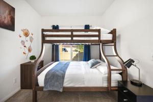 a bedroom with a bunk bed and a desk at Views, Gameroom, Saltwater Pool & Hot tub, Firepit by MariamsBnb in Desert Hot Springs +73 photos