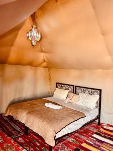 a large bed in a room with at Eco Merzouga luxury camp in Merzouga +21 photos