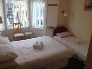 a bedroom with two beds with towels on them at Bel Reve Hotel in Blackpool