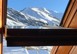 a view of a snow covered mountain from a window at Chalet les Aurores au coeur du village La Grave - La Meije in La Grave