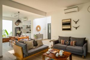 a living room with a couch and a table at La Olalian 2 & 3 BHK Designer Villas Near Anjuna Beach with Private Pool & Sun Deck & Garden in Anjuna