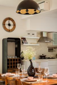 a dining room with a table and a vase with flowers at La Olalian by The Blue Kite - 2 & 3 BHK Designer Villas Near Anjuna Beach with Private Pool & Sun Deck & Garden in Anjuna