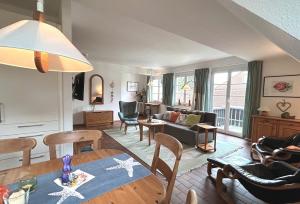 a living room with a couch and a table at Resi Q7 in Prerow