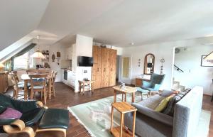 a living room with a couch and a table at Resi Q7 in Prerow