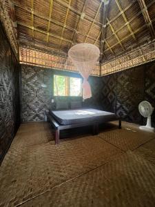 a room with a bed in a building with a window at Tiger home stay Phayam in Ko Phayam