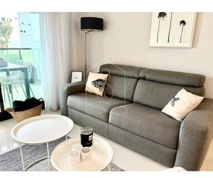 a living room with a couch and two tables at LONDON CANNES, vue mer in Cannes