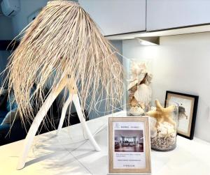 a museum exhibit with a picture on a table with a plant at LONDON CANNES, vue mer in Cannes