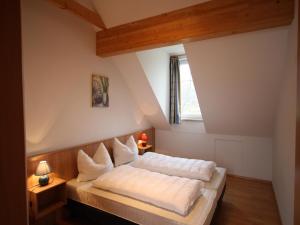 A bed or beds in a room at Apartment St Margarethen near Ski Lift