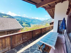 a balcony with a bench and a view of mountains at Chalet in Hippach near Ski Paradise in Hippach