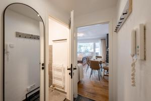 a hallway with a door leading to a dining room at Alpenstube mit Bergblick, Sauna und Hallenbad in Oberstdorf