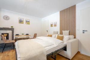 a white bedroom with a large bed and a fireplace at Alpenstube mit Bergblick, Sauna und Hallenbad in Oberstdorf +14 photos