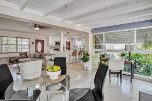 a dining room and living room with a table and chairs at Beautiful Comfy Home With Private Hot Tub Close To Beach home in Fort Lauderdale