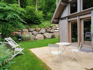 a group of chairs and a table in a yard at Cabanon in Sapois