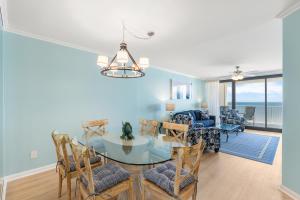 a dining room and living room with a table and chairs at Windward Pointe Condominiums in Orange Beach