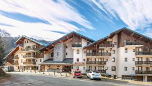 a large building with cars parked in front of it at La Turra 312 - 3P4 in Modane