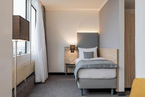 Postel nebo postele na pokoji v ubytování Garner Hotel Berlin - Spandau by IHG