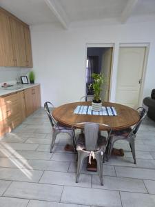 a kitchen with a wooden table with chairs and a table at Protea Guesthouse in Middelburg