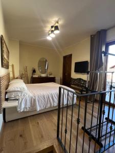 a bedroom with a bed and a television in it at CASA ENRICA in Adelfia