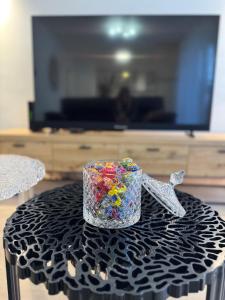 a glass cup filled with confetti sitting on a table at Maison des chênes in Bavilliers