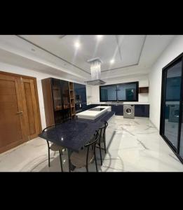 a kitchen with a table and chairs in a room at Villa Green in Hammamet