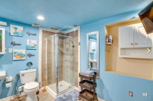 a blue bathroom with a shower and a toilet at PRIVATE ENTRANCE APT RooM #4 in Dallas +37 photos