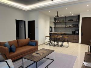 a living room with a couch and a table at Industrial Luxe Concrete Bliss, near Sunway Pyramid,Subang Jaya in Subang Jaya