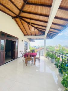 a dining room with a table and chairs on a balcony at Massimo Hotel Weligama in Weligama +12 photos