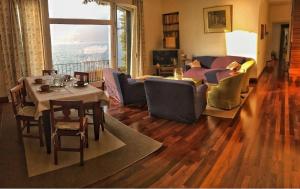 a living room with a couch and a table at On Lake Villa Cicci e Sandro in Bellano