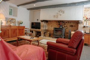 a living room with a couch and a fireplace at Dordogne - Belle maison pour 8 avec piscine in Saint-Rabier