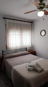 a bedroom with a bed with two towels on it at Apartamento Rural Casa Paco con Jacuzzi exterior y barbacoa in Aínsa