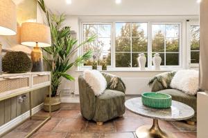 a living room with two chairs and a table at Great Easton Lodge in Great Easton