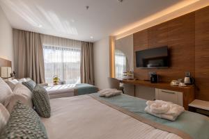 a hotel room with two beds and a flat screen tv at SIDE MOON PALACE in Side +37 photos