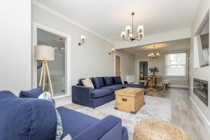 a living room with a blue couch and a table at Eller Cottage in Windermere