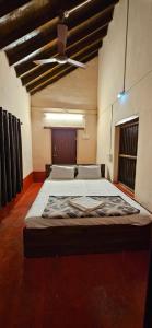 a large bed in a large room with a ceiling at Taramrata homestay Gokarna in Gokarna