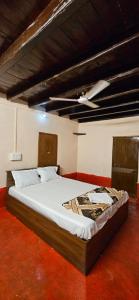 a large bed in a room with a ceiling at Taramrata homestay Gokarna in Gokarna