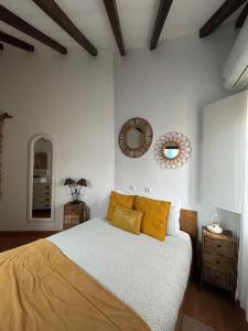 a bedroom with a bed with yellow pillows and a mirror at Red House- Historic center in Porto